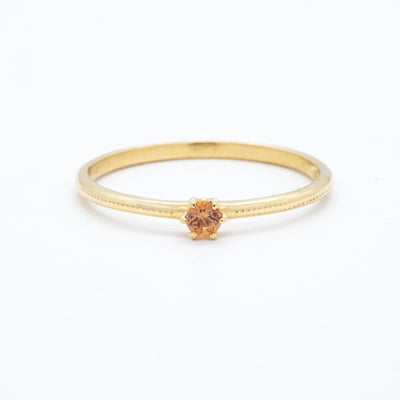 Golden ring with labgrown orange sapphire as centerstone