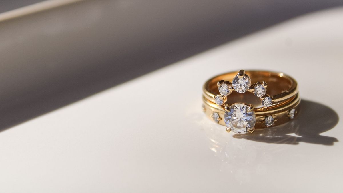 Sustainable engagement ring in recycled 18K gold with lab grown diamond styled as a modern bridal stack