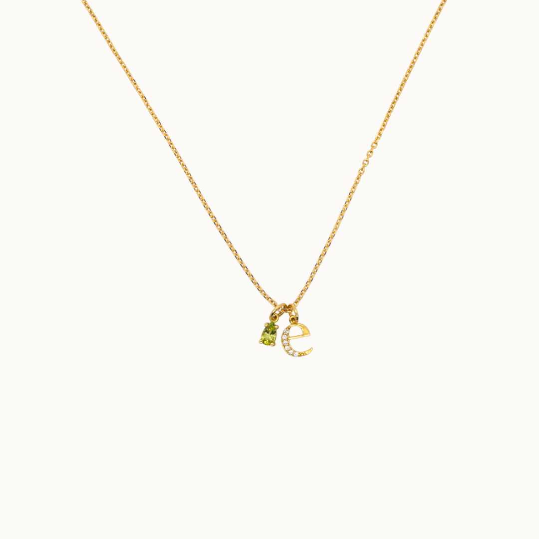 18 carat gold delicate trace necklace featuring dangling gemstone charms, birthstone charm necklace and an initial or letter charm with labgrown diamonds on a delicate chain