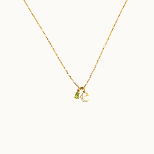 18 carat gold delicate trace necklace featuring dangling gemstone charms, birthstone charm necklace and an initial or letter charm with labgrown diamonds on a delicate chain