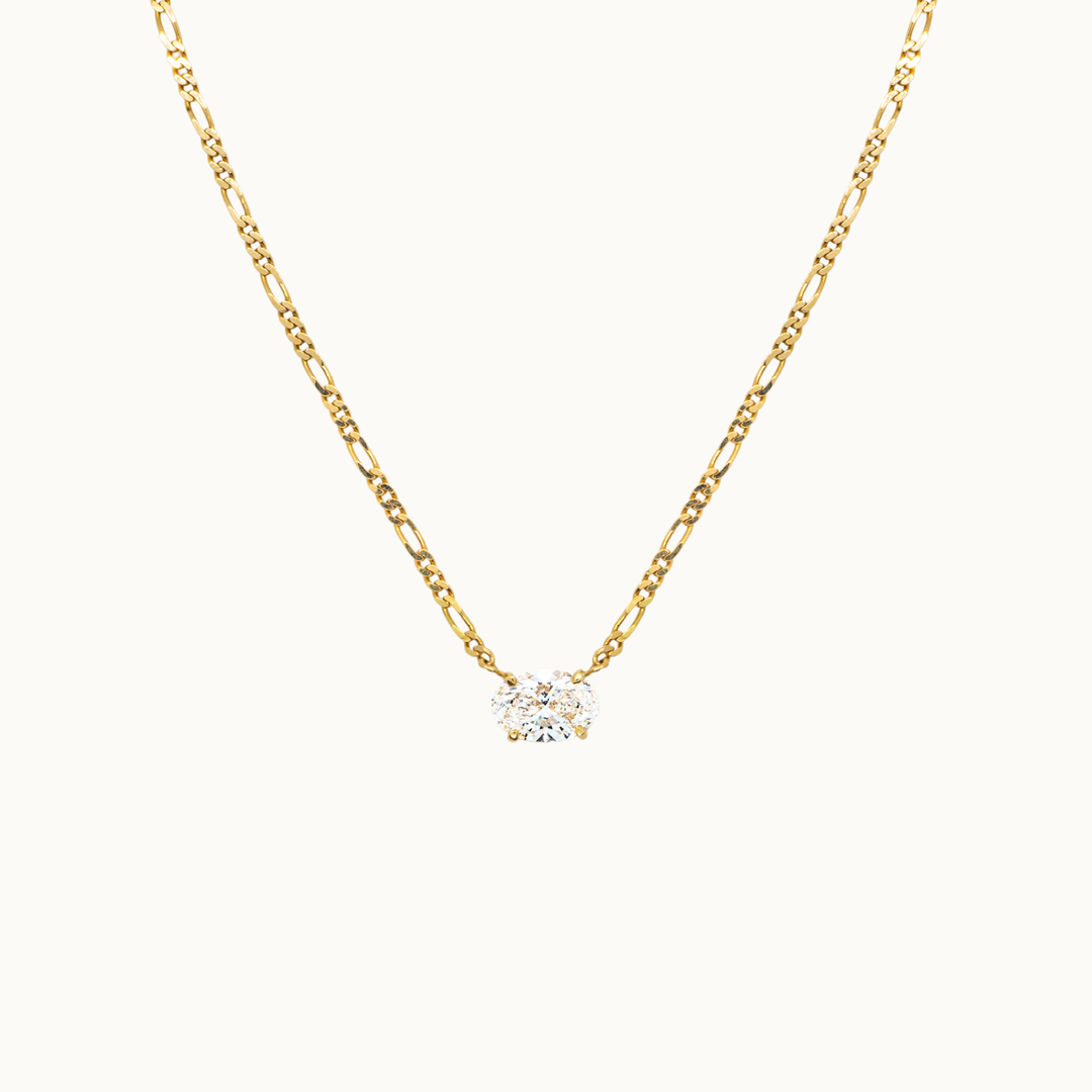 18 carat gold figaro chain necklace featuring a single solitaire 2 carat oval labgrown diamond pendant in a minimalist setting.