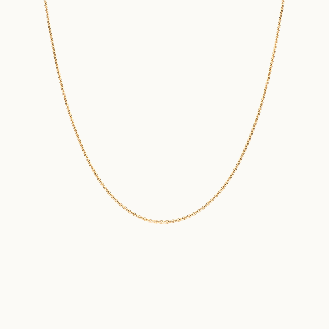 18 carat gold delicate trace chain necklace on a white background