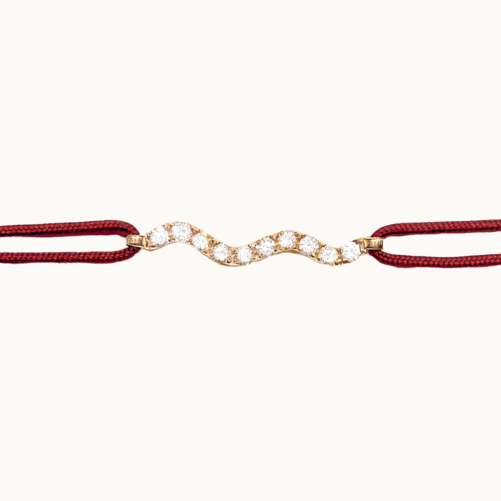 Cordelia wave-shaped labgrown diamond charm bracelet with burgundy red adjustable and customizable cord and 18 carat gold setting