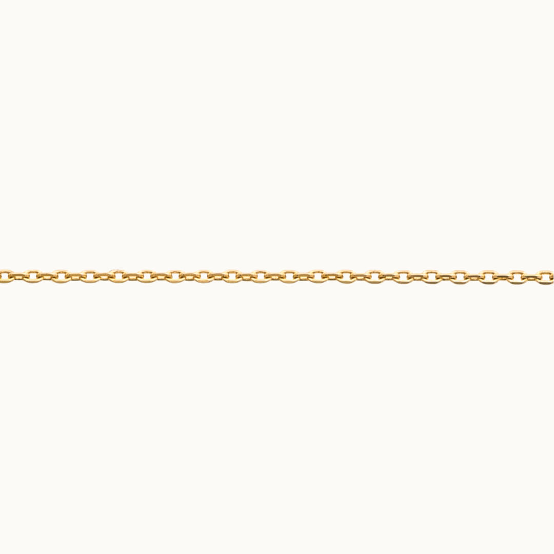 Detail of 18 carat gold delicate trace chain necklace on a white background