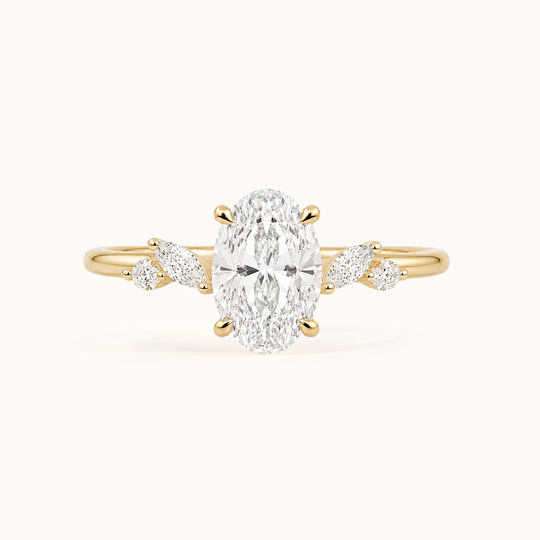 Vintage inspired floral engagement ring in recycled 18K yellow gold with oval and marquise-shaped lab-grown diamonds