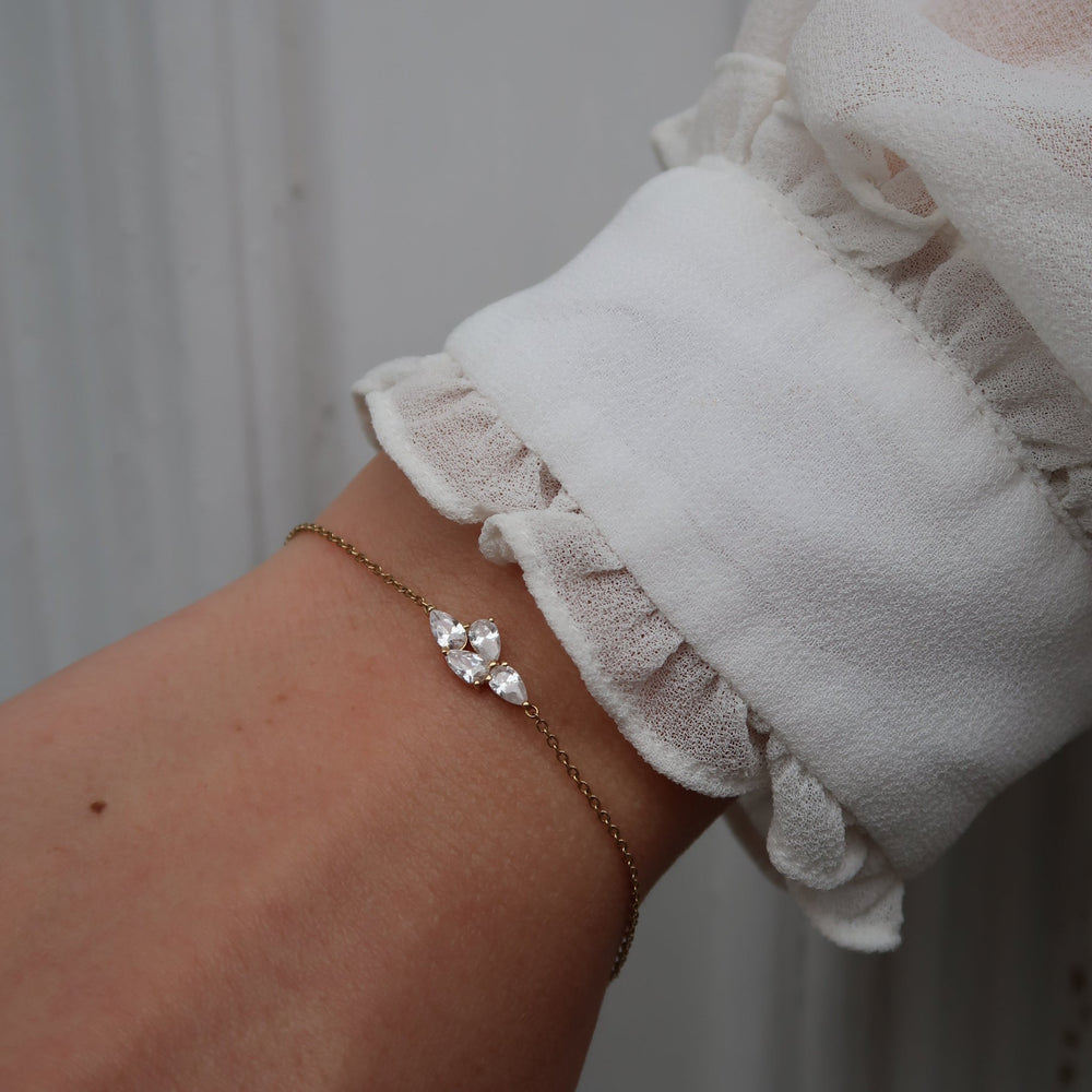 Model wearing the Bloom Bracelet with pear-cut lab-grown diamonds in recycled 18K gold