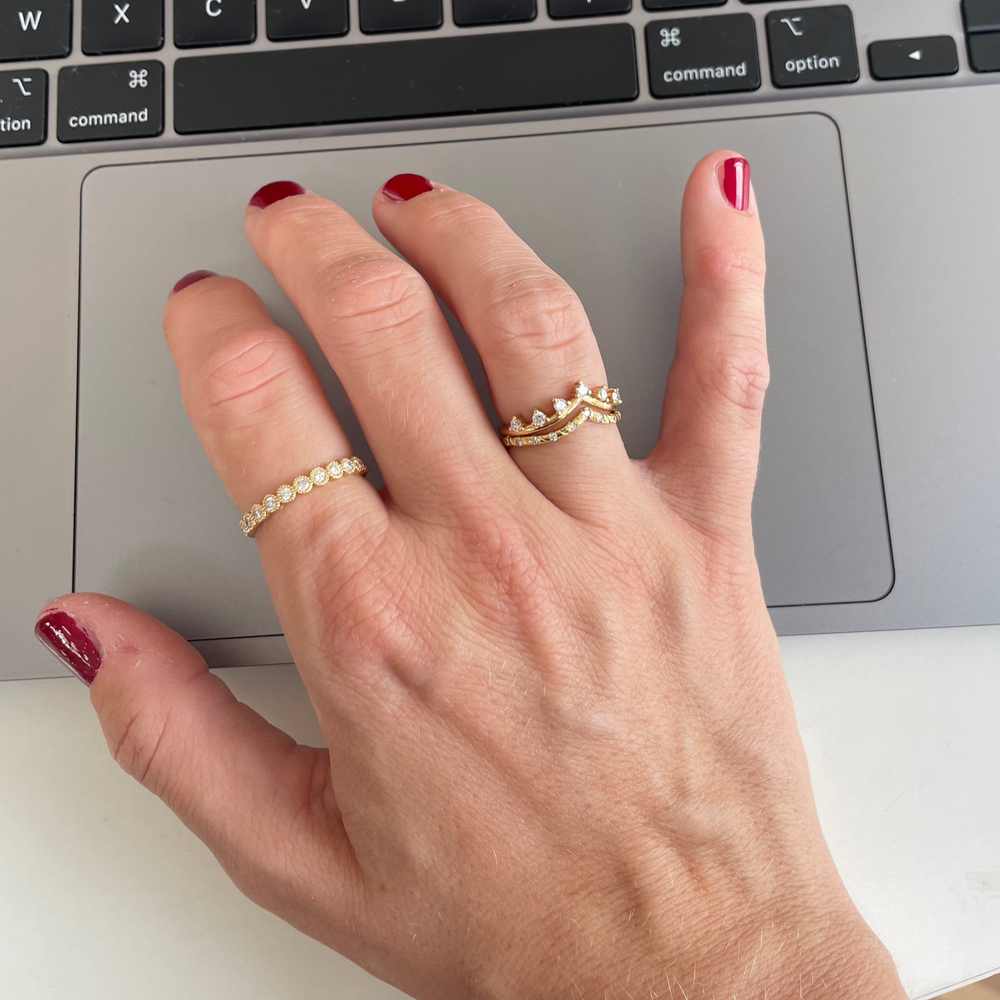 Alyssa Ring in yellow gold worn on the hand with a second stacking ring