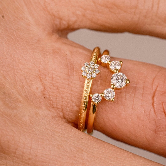 Flora Ring close-up worn in a stack – 18k gold floral ring with lab-grown diamonds