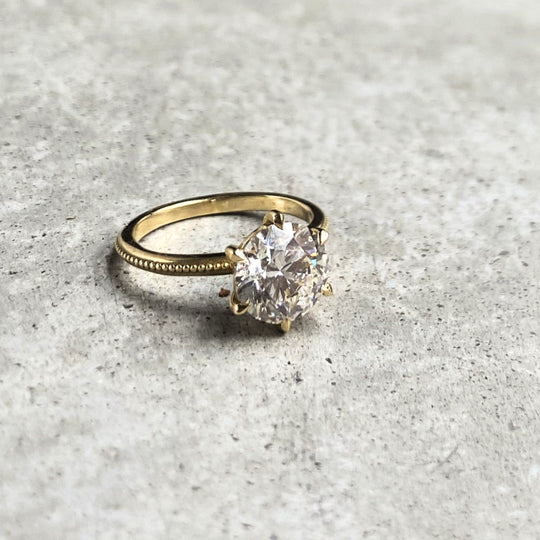 Laurel Solitaire on stone, a round lab-grown diamond in six claws on a beaded band, recycled 18K yellow gold