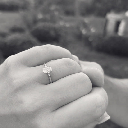 Primrose Oval worn on the hand, an oval lab-grown diamond solitaire, in black and white