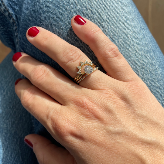 1 carat lab-grown engagement ring worn on hand and stacked with wedding ring and crown ring for daily wear on jeans in Antwerp.