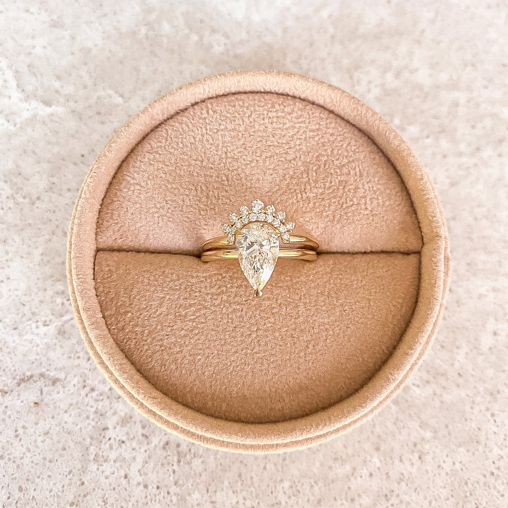 Primrose Pear stacked with a diamond crown band in a velvet ring box, recycled 18K yellow gold