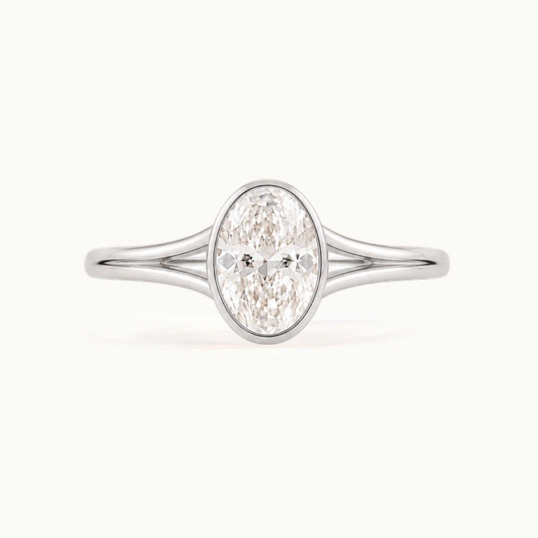 Aveline Ring, an oval lab-grown diamond in a bezel on a split shank, recycled 18K white gold
