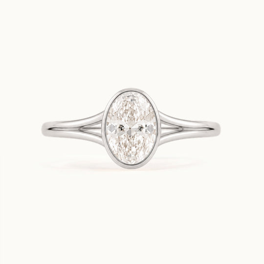 Aveline Ring, an oval lab-grown diamond in a bezel on a split shank, recycled 18K white gold