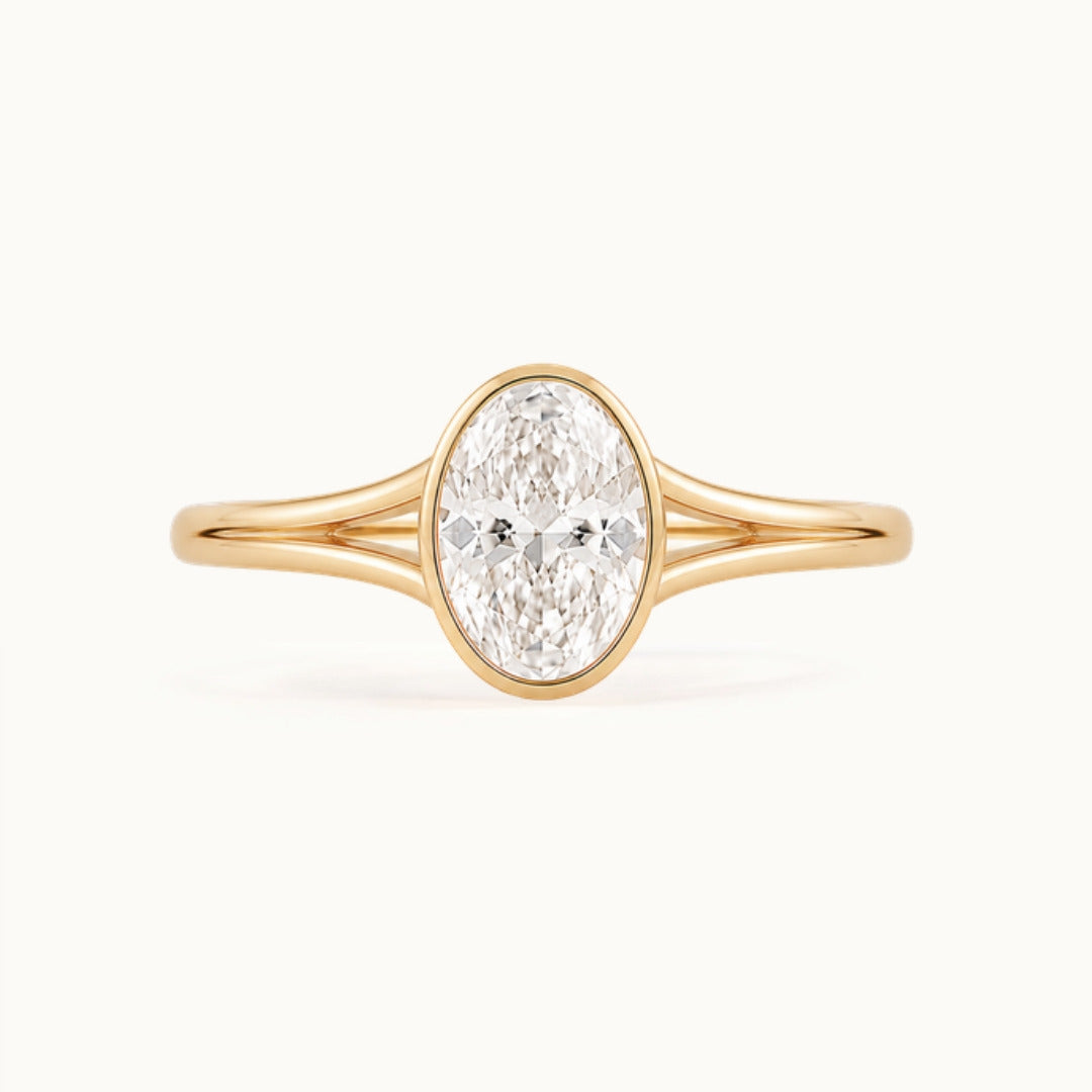 Aveline Ring, an oval lab-grown diamond in a bezel on a split shank, recycled 18K yellow gold