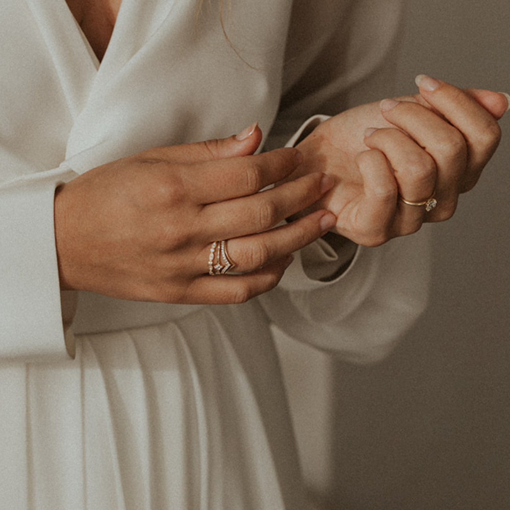 Bride wearing Juna Fae’s ethically crafted wedding rings, featuring 18k recycled gold and lab-grown diamonds. A timeless symbol of love and sustainability, captured in an elegant and romantic moment.