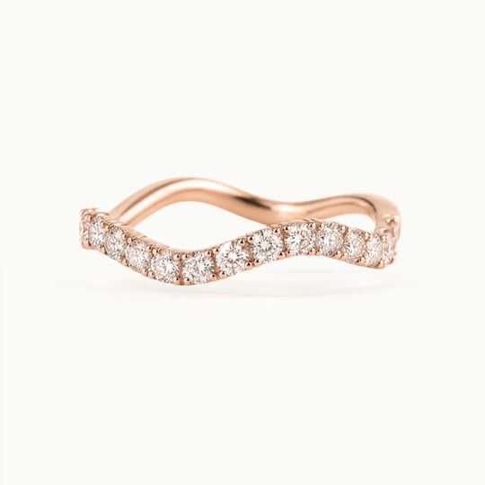 Cordelia Grand Ring, a wave-shaped band of larger lab-grown diamonds in recycled 18K rose gold