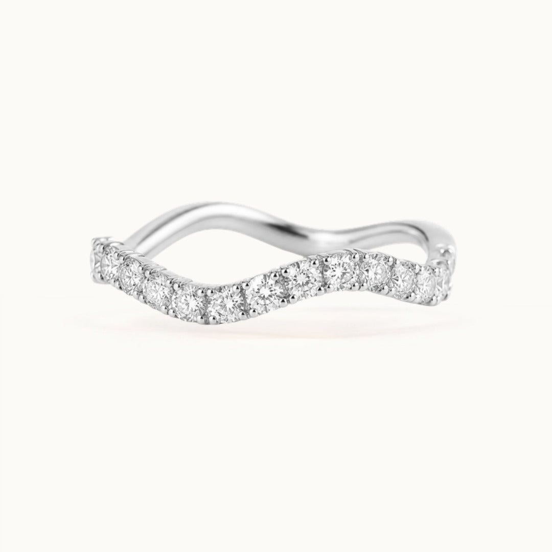 Cordelia Grand Ring, a wave-shaped band of larger lab-grown diamonds in recycled 18K white gold