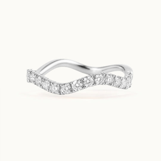 Cordelia Grand Ring, a wave-shaped band of larger lab-grown diamonds in recycled 18K white gold