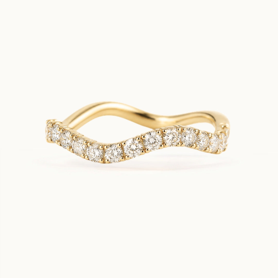Cordelia Grand Ring, a wave-shaped band of larger lab-grown diamonds in recycled 18K yellow gold