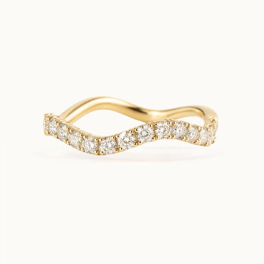 Cordelia Grand Ring, a wave-shaped band of larger lab-grown diamonds in recycled 18K yellow gold