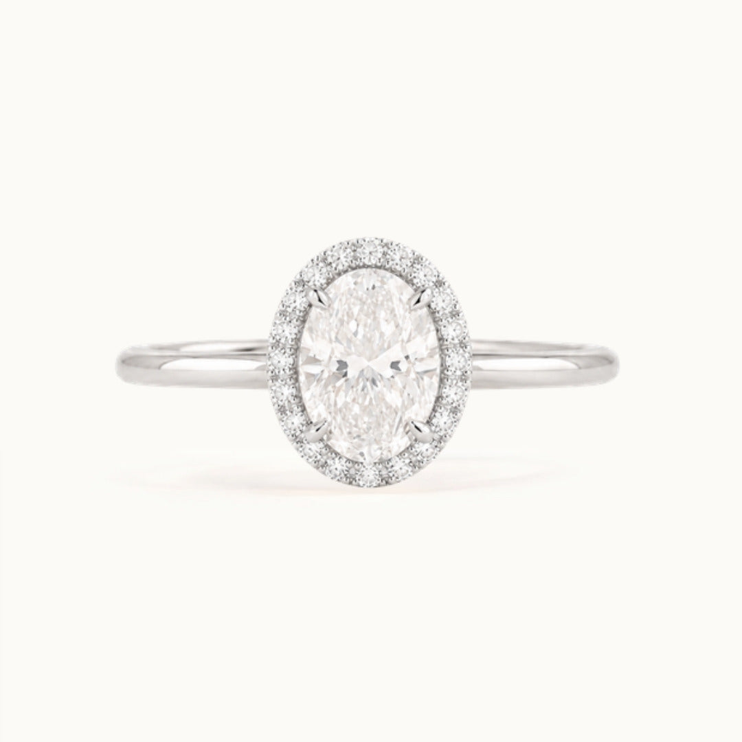 Dahlia Ring, an oval lab-grown diamond in a diamond halo, recycled 18K white gold