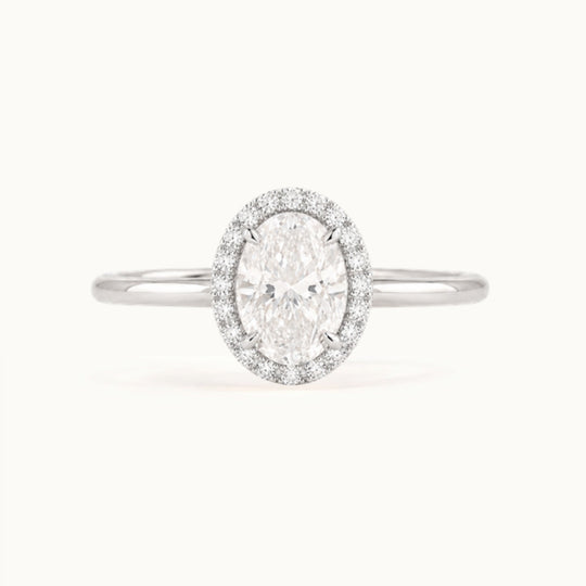Dahlia Ring, an oval lab-grown diamond in a diamond halo, recycled 18K white gold