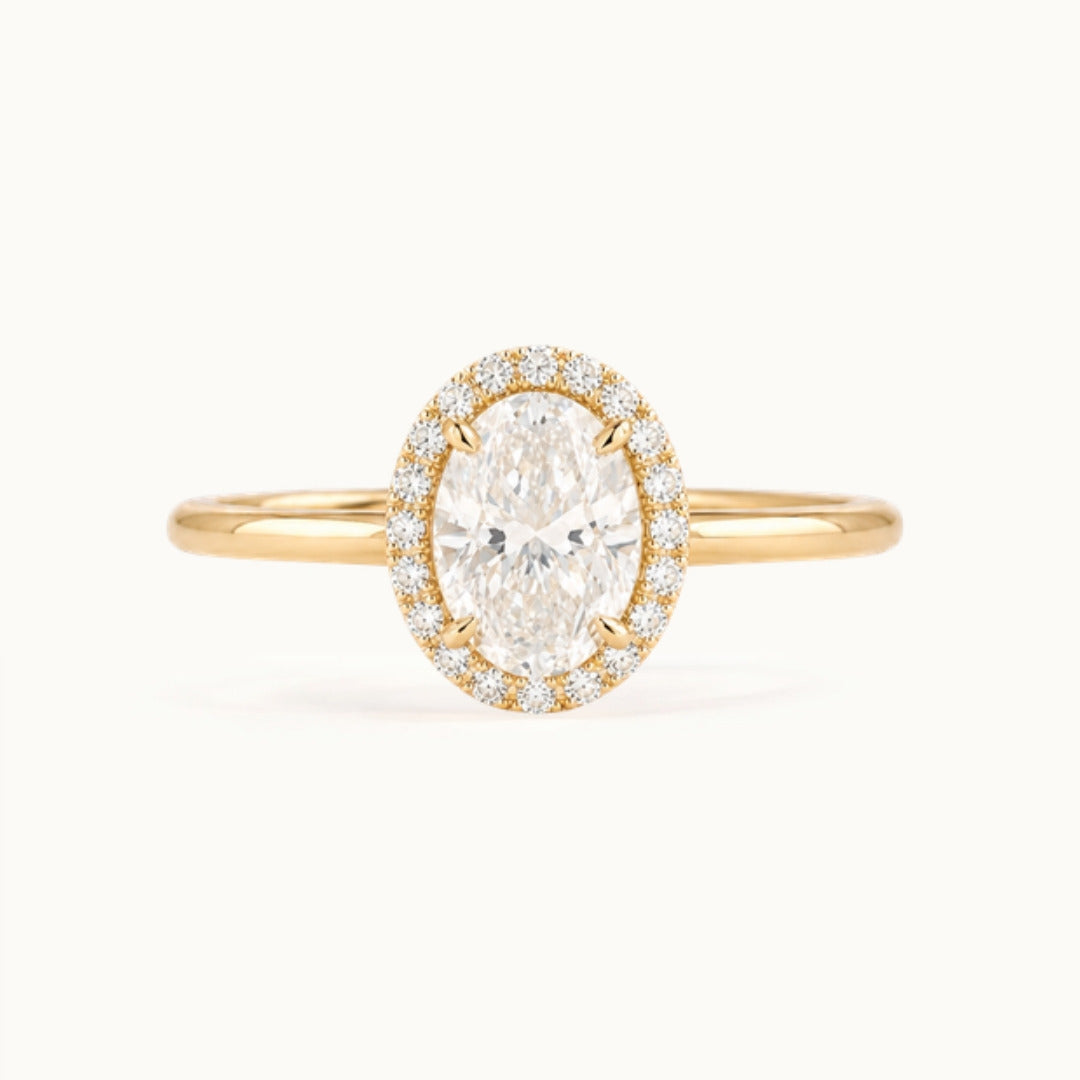 Dahlia Ring, an oval lab-grown diamond in a diamond halo, recycled 18K yellow gold