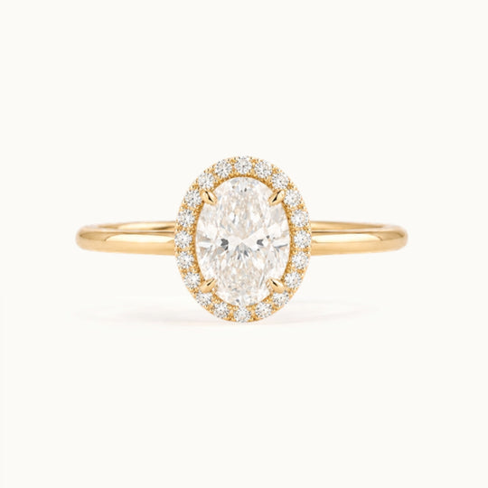 Dahlia Ring, an oval lab-grown diamond in a diamond halo, recycled 18K yellow gold