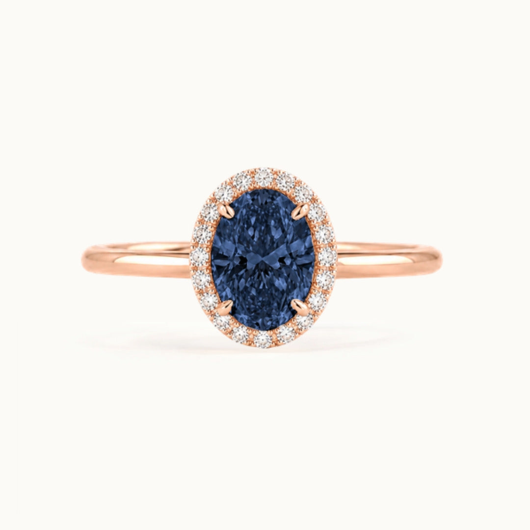 Dahlia Sapphire Ring, an oval blue sapphire in a lab-grown diamond halo, recycled 18K rose gold