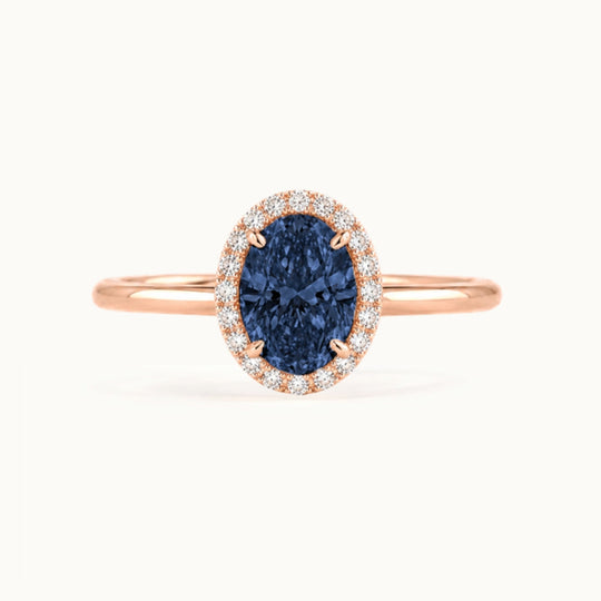 Dahlia Sapphire Ring, an oval blue sapphire in a lab-grown diamond halo, recycled 18K rose gold