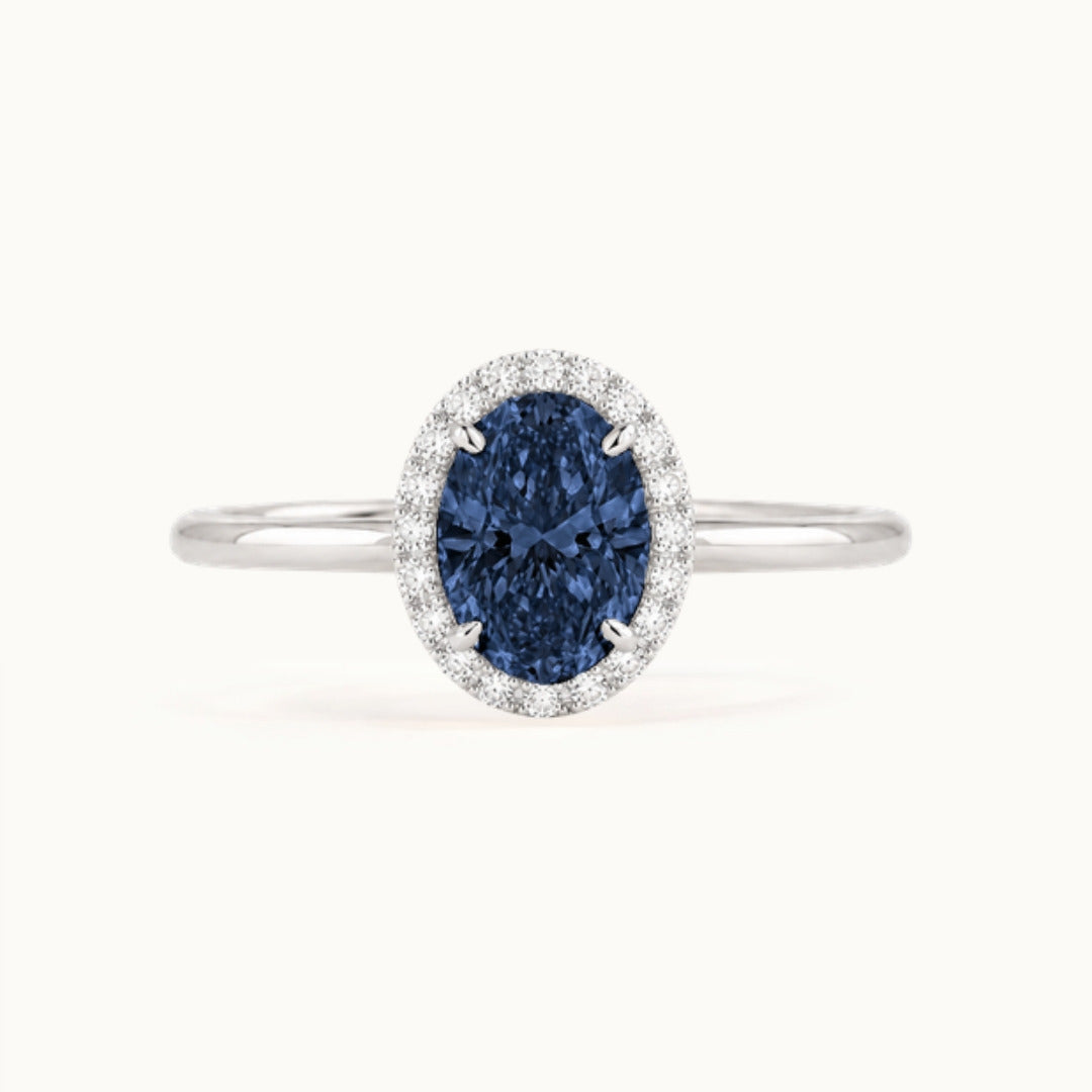 Dahlia Sapphire Ring, an oval blue sapphire in a lab-grown diamond halo, recycled 18K white gold