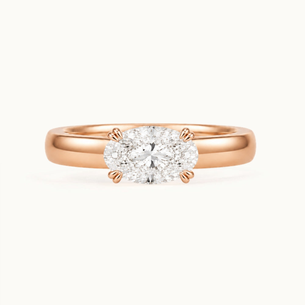 Genevieve Ring, an east-west oval lab-grown diamond on a wide band, recycled 18K rose gold