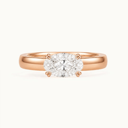 Genevieve Ring, an east-west oval lab-grown diamond on a wide band, recycled 18K rose gold