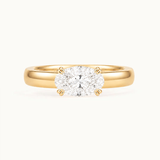 Genevieve Ring, an east-west oval lab-grown diamond on a wide band, recycled 18K yellow gold
