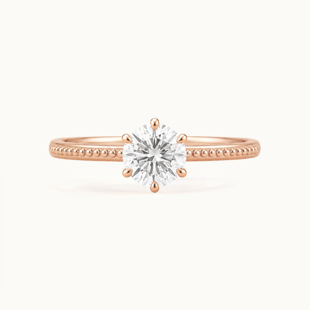 Laurel Ring, a round lab-grown diamond in six claws on a beaded band, recycled 18K rose gold