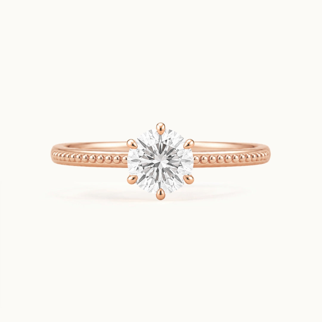 Laurel Ring, a round lab-grown diamond in six claws on a beaded band, recycled 18K rose gold