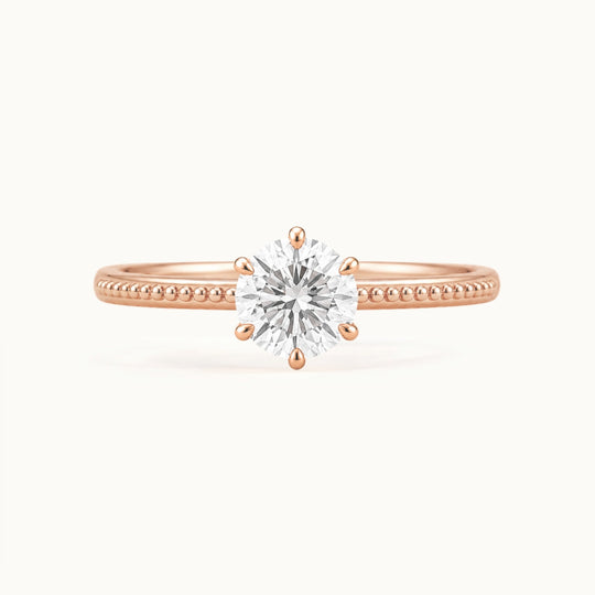 Laurel Ring, a round lab-grown diamond in six claws on a beaded band, recycled 18K rose gold