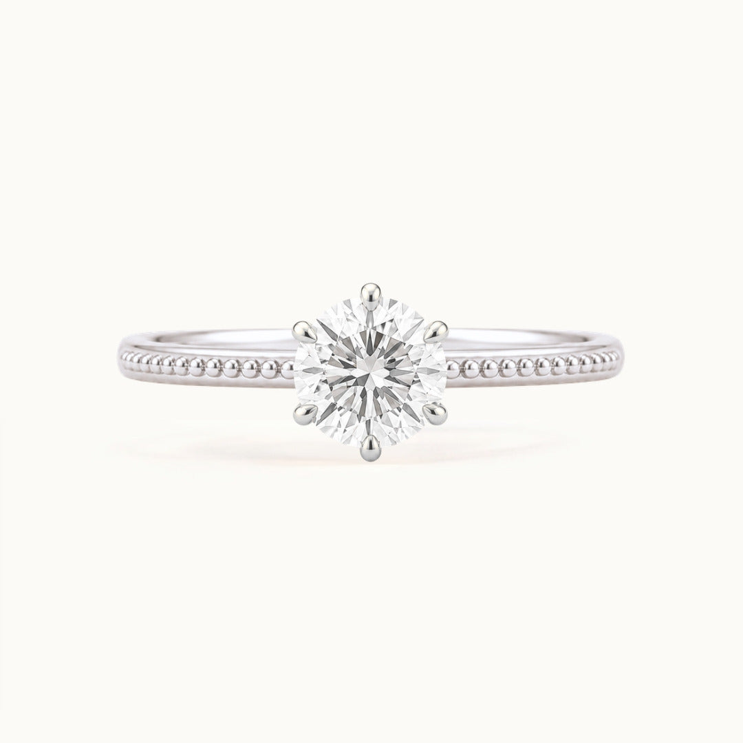Laurel Ring, a round lab-grown diamond in six claws on a beaded band, recycled 18K white gold