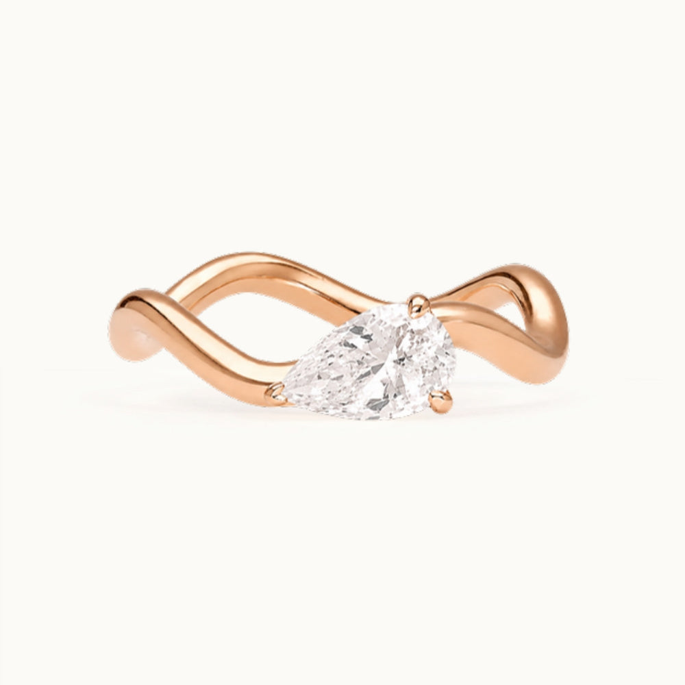 Selina Ring, a pear-shaped lab-grown diamond on a wave band, recycled 18K rose gold