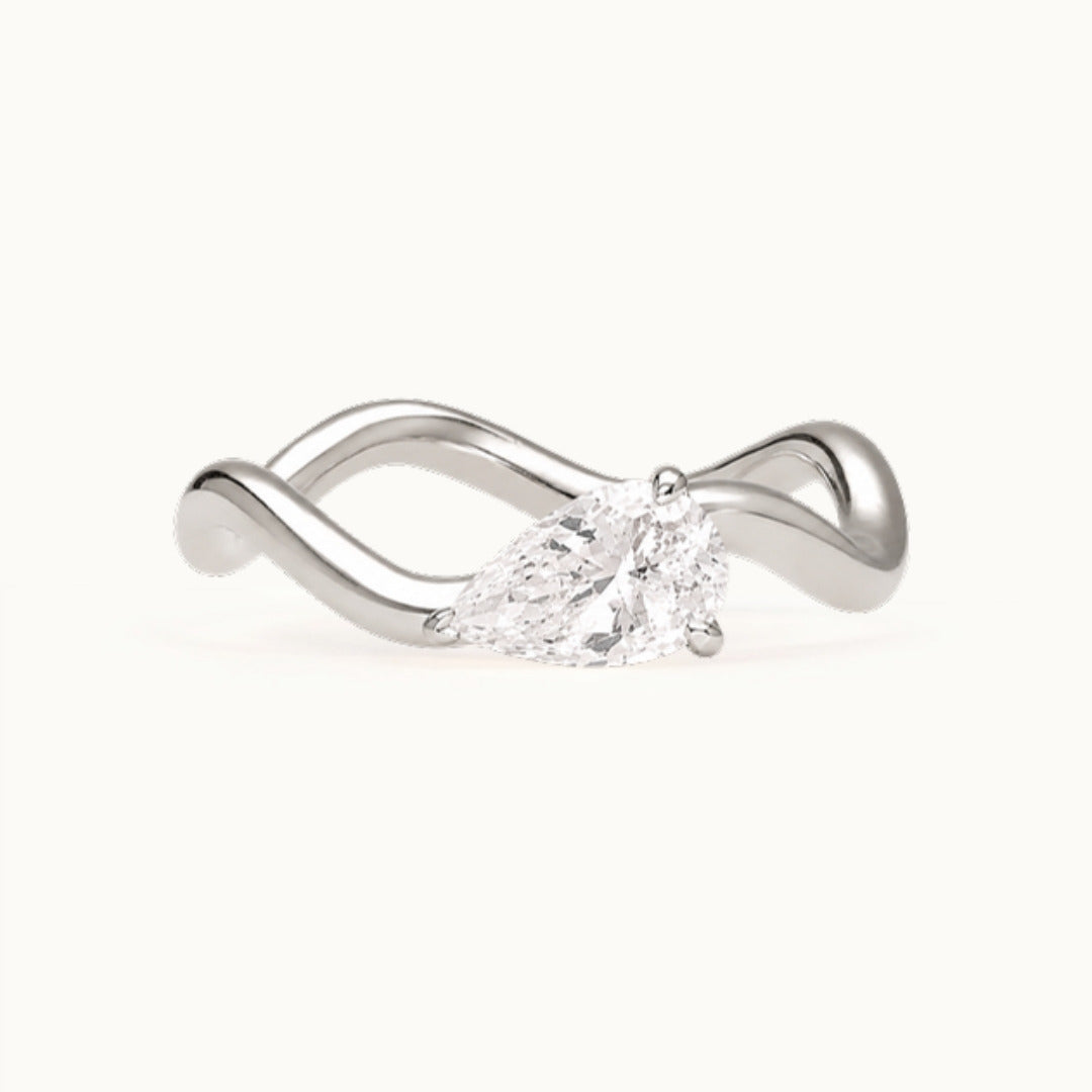 Selina Ring, a pear-shaped lab-grown diamond on a wave band, recycled 18K white gold