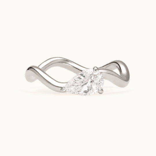 Selina Ring, a pear-shaped lab-grown diamond on a wave band, recycled 18K white gold