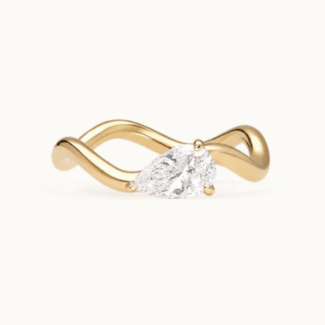 Selina Ring, a pear-shaped lab-grown diamond on a wave band, recycled 18K yellow gold