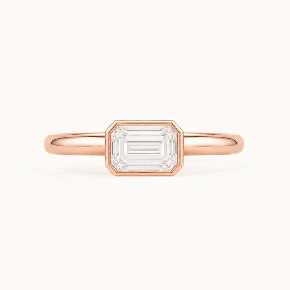 Simone Ring, an east-west emerald-cut lab-grown diamond in a bezel, recycled 18K rose gold