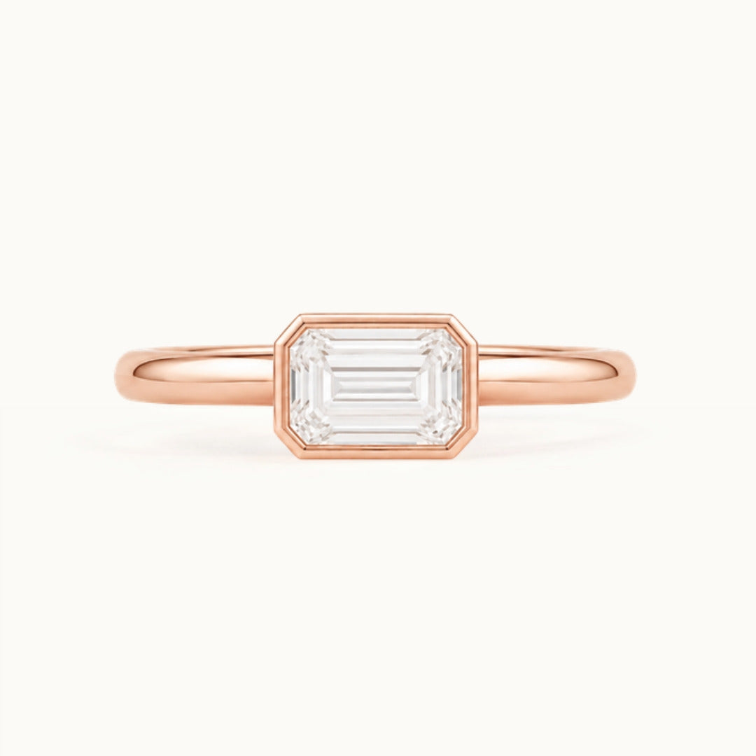 Simone Ring, an east-west emerald-cut lab-grown diamond in a bezel, recycled 18K rose gold