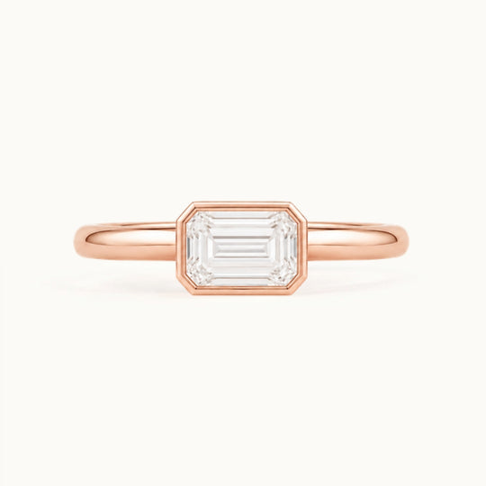 Simone Ring, an east-west emerald-cut lab-grown diamond in a bezel, recycled 18K rose gold