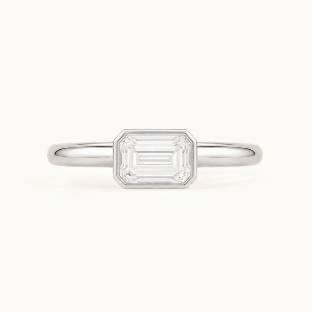 Simone Ring, an east-west emerald-cut lab-grown diamond in a bezel, recycled 18K white gold