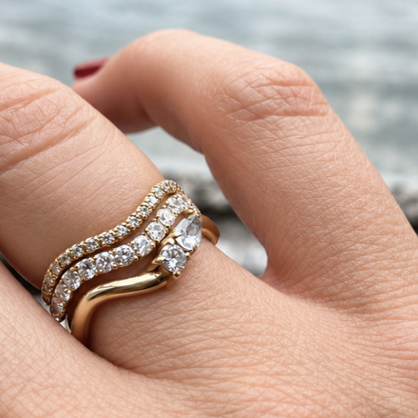 Cordelia Grand Ring worn with diamond wave rings and a pear-cut diamond ring, recycled 18K yellow gold