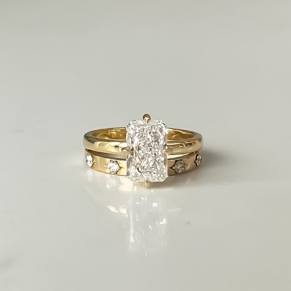 Vivienne Ring stacked with a diamond band, a radiant-cut lab-grown diamond solitaire in recycled 18K yellow gold