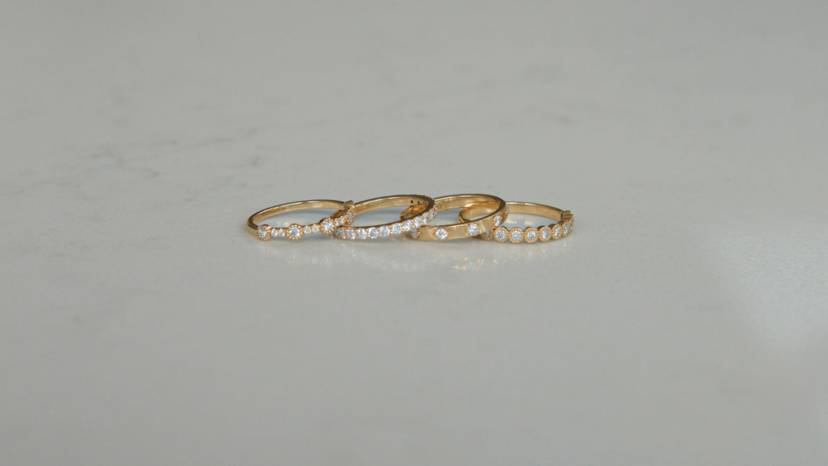 Set of four 18K gold labgrown diamond rings by Juna Fae, designed as stackable bands perfect for wedding rings or everyday rings to celebrate life’s special moments, all created in Antwerp with an ethical and sustainable production. 